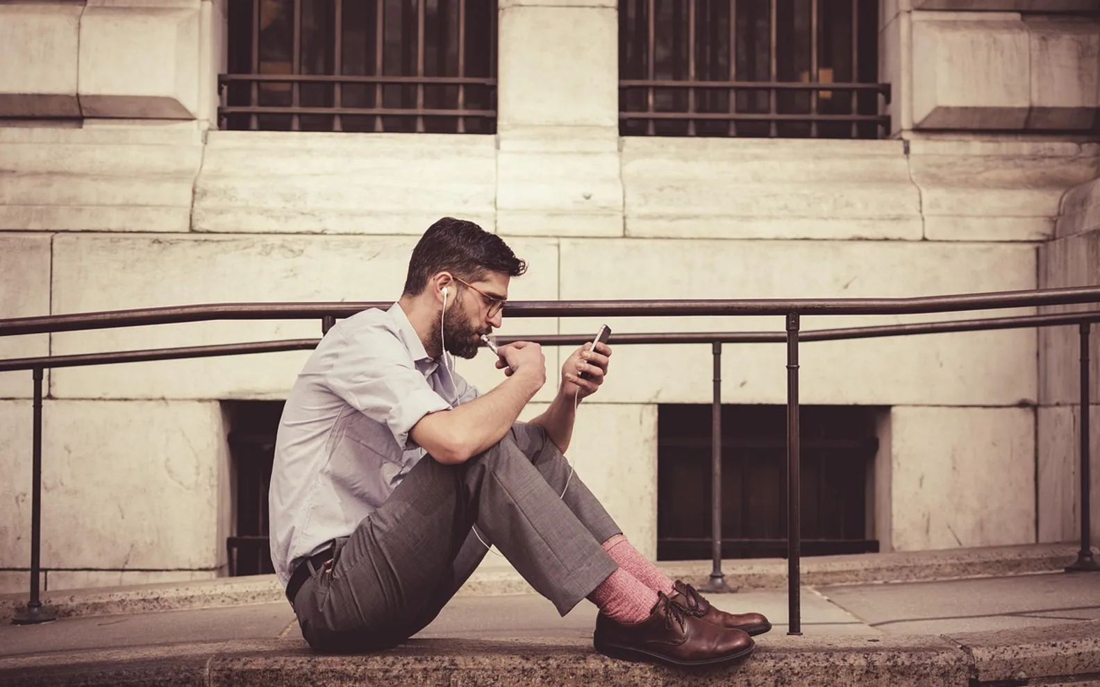 Brown leather shoes, man and earphones